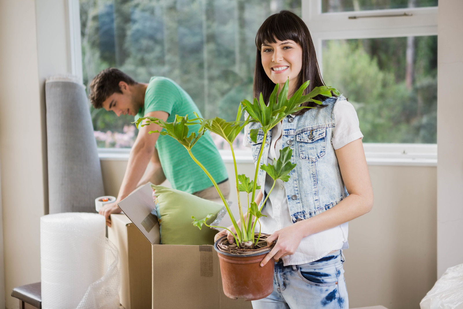 21611200-young-couple-unpacking-carton-boxes-in-their-new-house